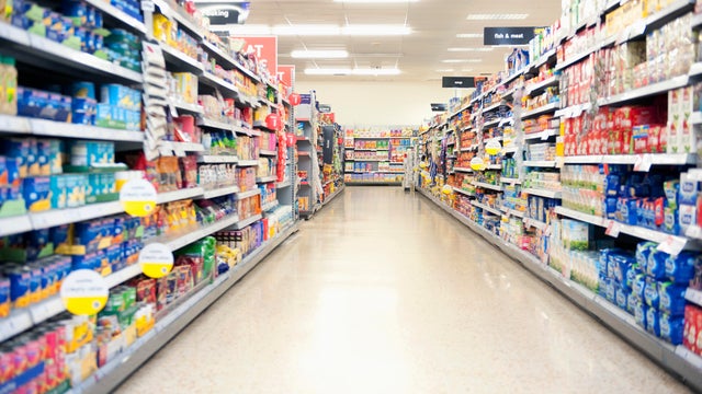 Shelves in grocery store aisle 