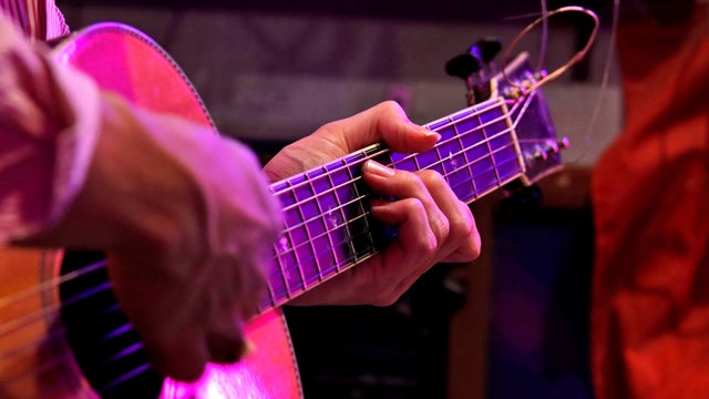 Man playing an acoustic guitar on stage 
