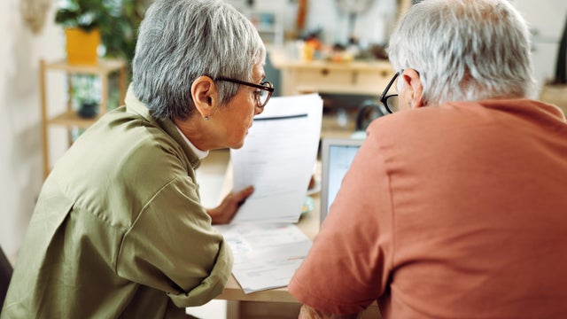 Senior couple going over bills at home 